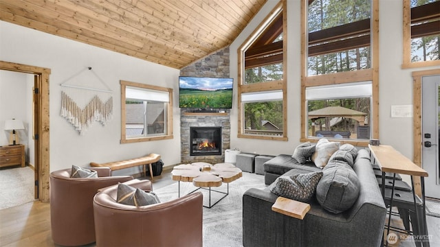 living room with a fireplace, high vaulted ceiling, wood ceiling, and wood finished floors