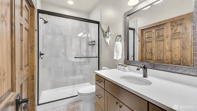full bath with vanity, tile patterned floors, a shower stall, and toilet