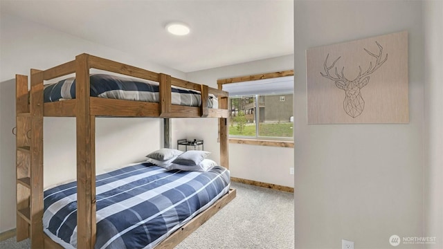 bedroom featuring baseboards and carpet flooring