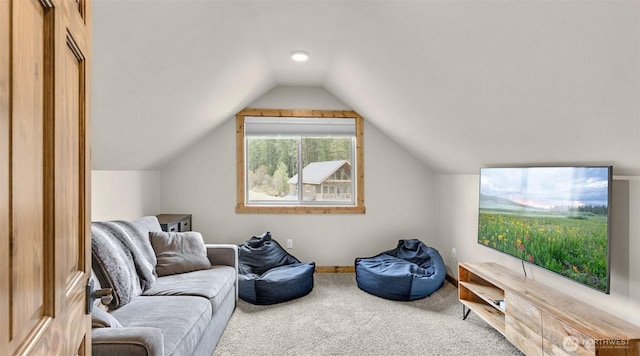 living area with carpet and vaulted ceiling