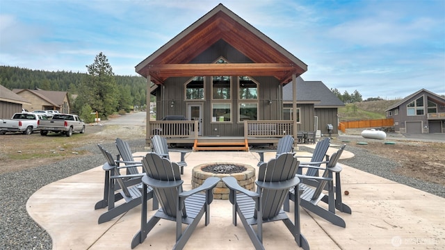 view of patio with an outdoor fire pit and a wooden deck