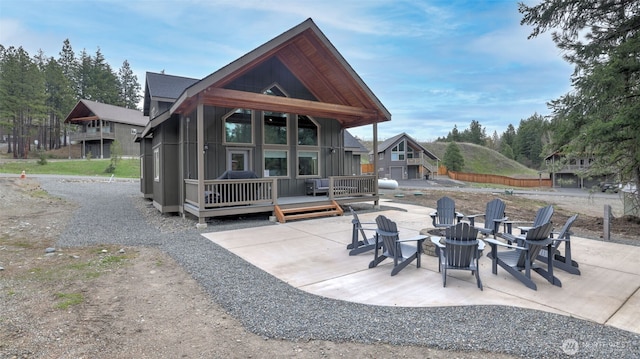 view of patio / terrace with an outdoor fire pit and a wooden deck