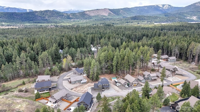 bird's eye view with a mountain view and a forest view