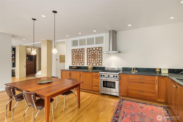 28091/2 Mount Rainier Dr S Unit 4, Seattle, WA 98144 - kitchen featuring wall chimney range hood, high end range, light wood finished floors, dark countertops, and recessed lighting