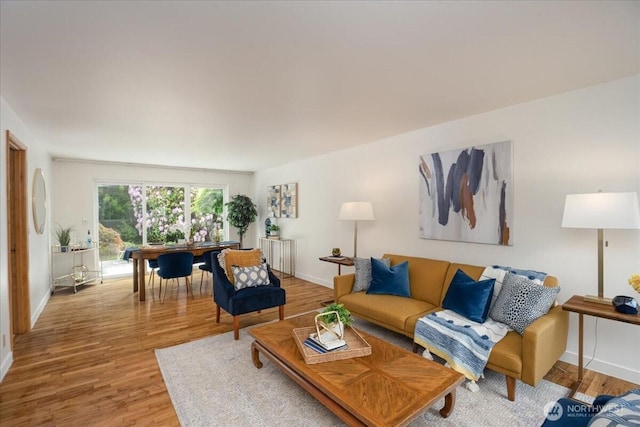 living room featuring radiator, baseboards, and wood finished floors