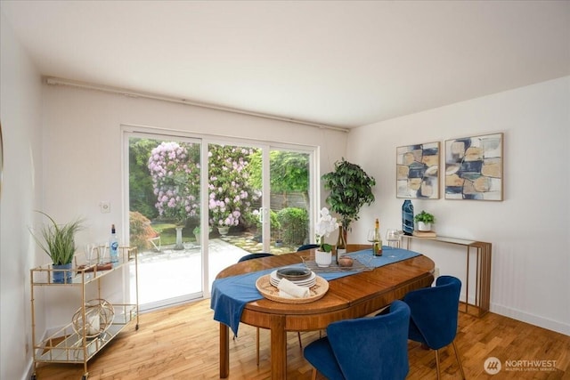 dining room with light wood-style flooring and baseboards
