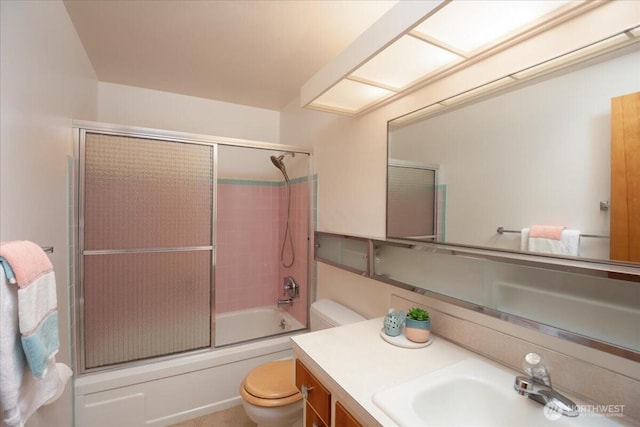 full bathroom featuring toilet, vanity, and combined bath / shower with glass door