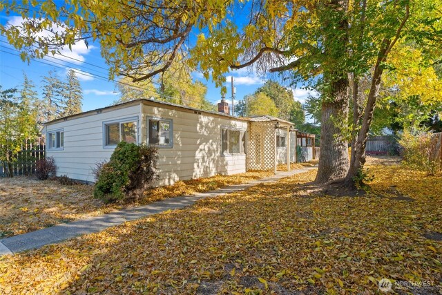 406 S Chestnut St, Ellensburg, WA 98926 - view of side of home with a chimney and fence