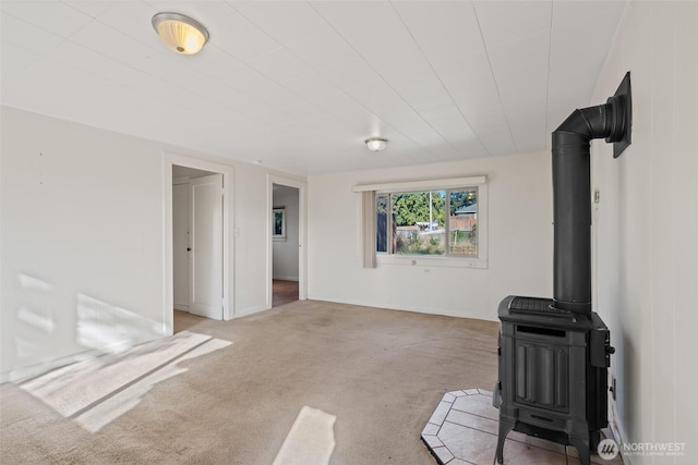 406 S Chestnut St, Ellensburg, WA 98926 - unfurnished living room with carpet floors and a wood stove