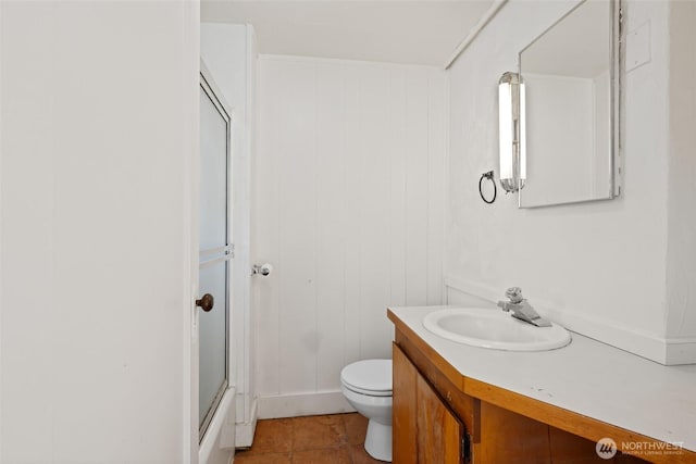 406 S Chestnut St, Ellensburg, WA 98926 - bathroom featuring tile patterned flooring, toilet, vanity, and a shower with door