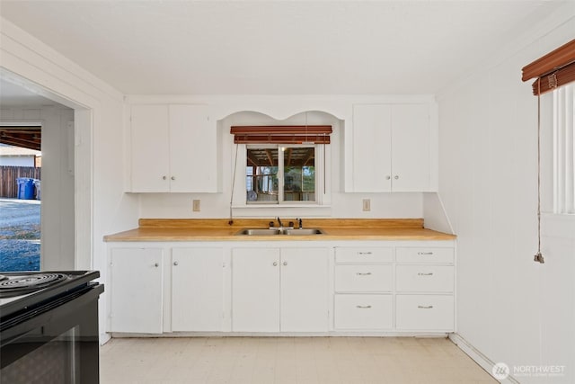 406 S Chestnut St, Ellensburg, WA 98926 - kitchen with white cabinets, a sink, black / electric stove, and light countertops