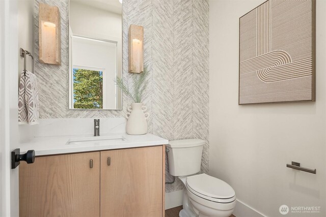 bathroom featuring toilet and vanity