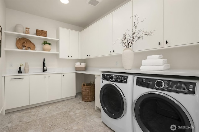 washroom with separate washer and dryer and cabinet space