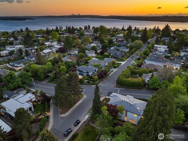 aerial overview of property's location featuring nearby suburban area and a nearby body of water