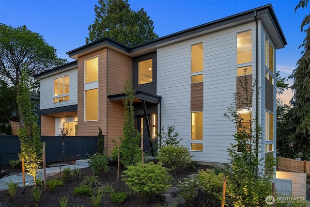 contemporary home with fence