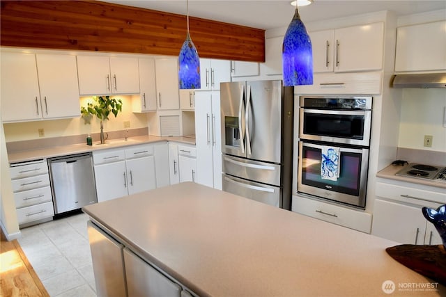 2426 Eastpoint Dr, Langley, WA 98260 - kitchen with appliances with stainless steel finishes, ventilation hood, white cabinetry, and light tile patterned floors