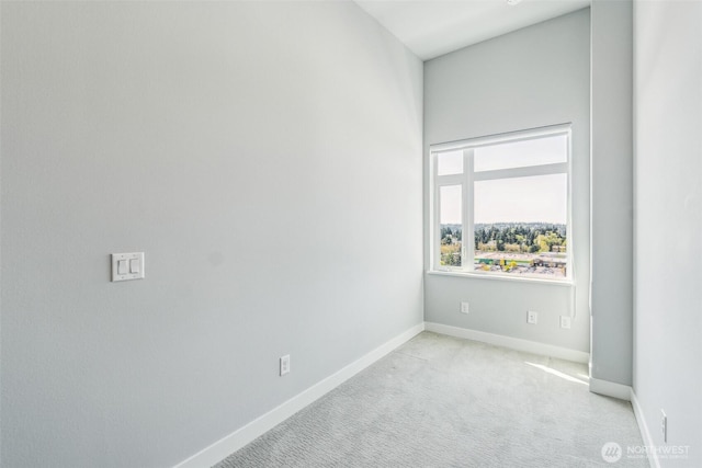 carpeted empty room with baseboards