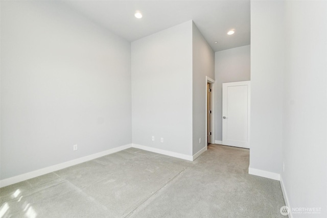 carpeted spare room featuring recessed lighting and baseboards
