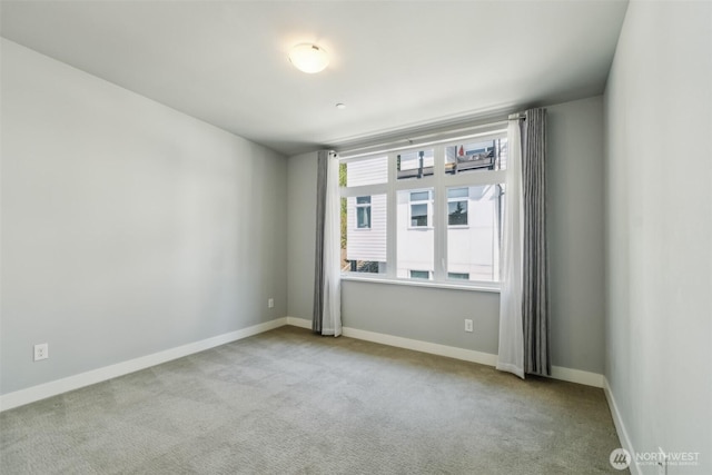 spare room with carpet floors and baseboards