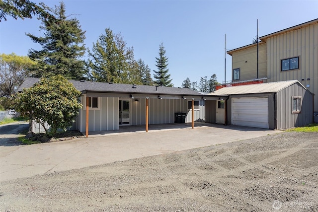 view of front of property featuring concrete driveway and board and batten siding