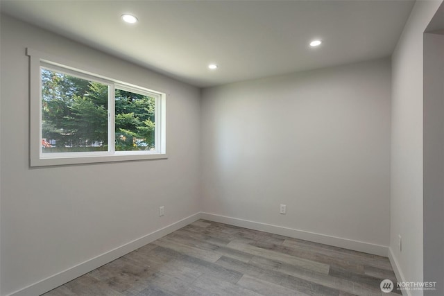 unfurnished room featuring recessed lighting, baseboards, and light wood-style floors