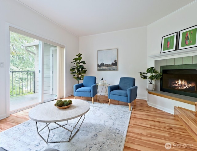 4350 W Lake Sammamish Pkwy SE Unit 133, Issaquah, WA 98027 - living area with wood finished floors, a fireplace, baseboards, and crown molding