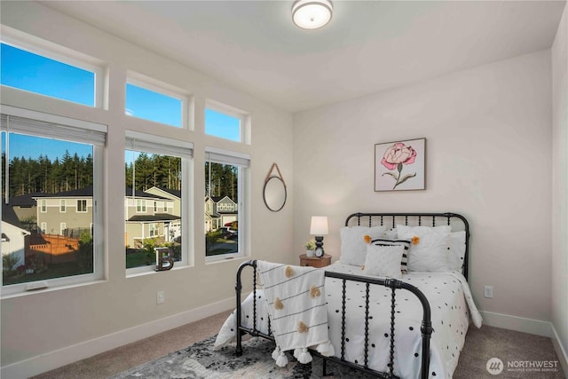 carpeted bedroom featuring baseboards