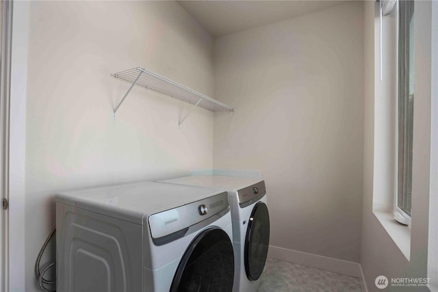 laundry area featuring separate washer and dryer, laundry area, and baseboards
