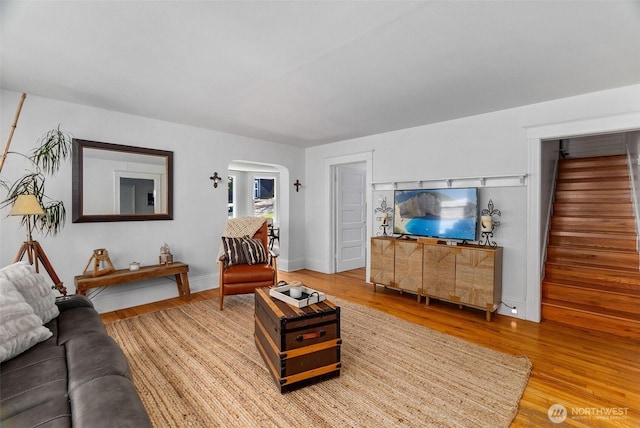 707 N 10th St, Tacoma, WA 98403 - living area featuring light wood-style flooring, baseboards, arched walkways, and stairs