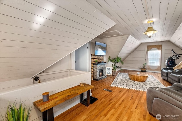 707 N 10th St, Tacoma, WA 98403 - living area featuring wood ceiling, wood-type flooring, vaulted ceiling, and a stone fireplace