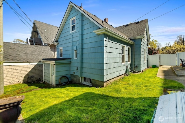 707 N 10th St, Tacoma, WA 98403 - view of side of property with roof with shingles, a gate, a chimney, fence, and a lawn