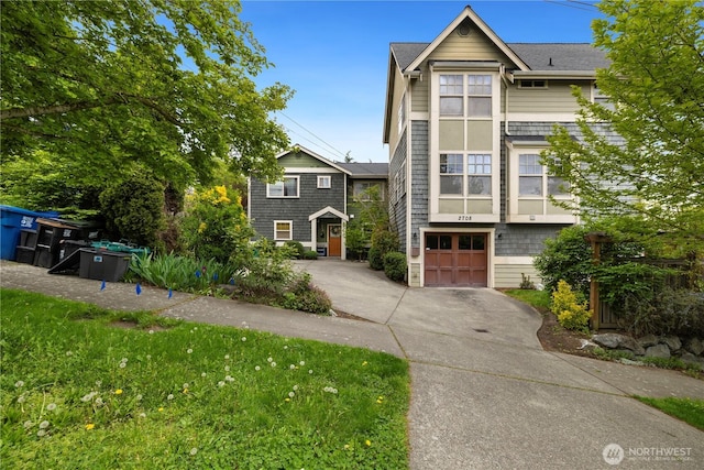 multi unit property featuring an attached garage and concrete driveway