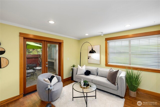 living area with baseboards, french doors, recessed lighting, and wood finished floors