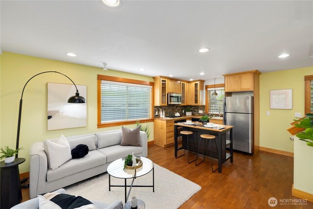 living room with baseboards, recessed lighting, and dark wood-type flooring