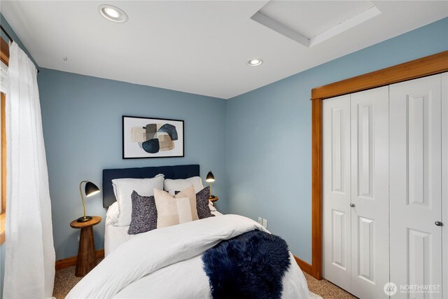 carpeted bedroom with baseboards, attic access, recessed lighting, and a closet