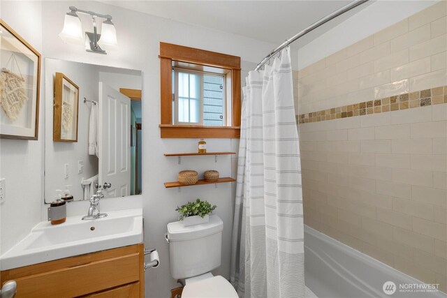 bathroom with vanity, toilet, and shower / bath combination with curtain