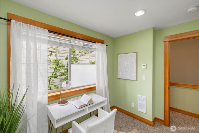 dining space featuring baseboards and carpet flooring