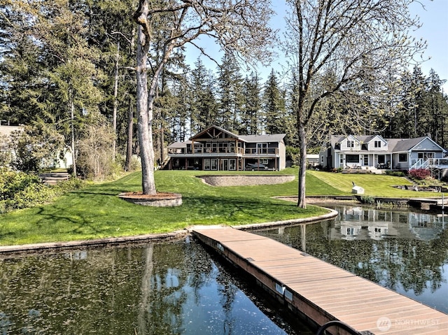 dock area featuring a lawn and a water view