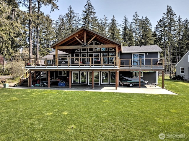 back of property featuring a wooden deck, a yard, a patio, and stairway