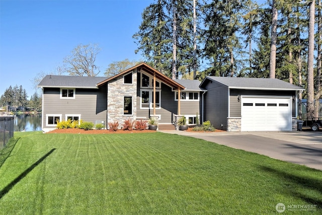 mid-century inspired home featuring stone siding, a front lawn, fence, and concrete driveway