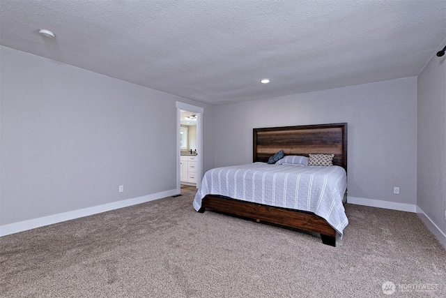 bedroom with baseboards, carpet flooring, and a textured ceiling
