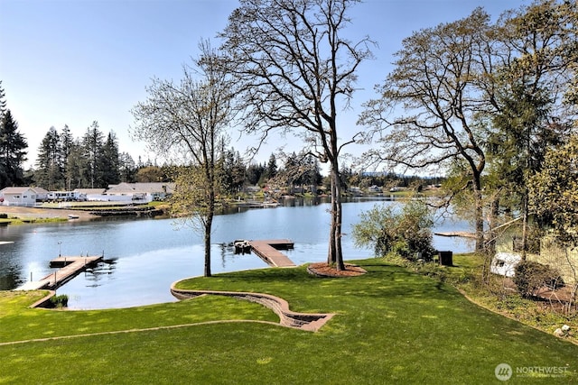 exterior space with a lawn and a water view