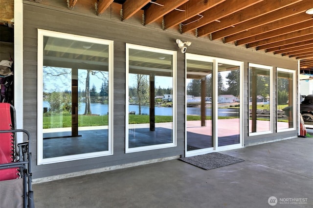 entryway featuring concrete flooring and a water view