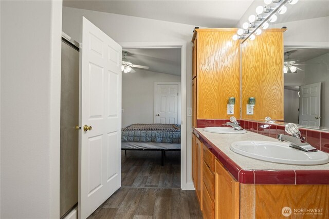 ensuite bathroom with wood finished floors, a sink, and ceiling fan