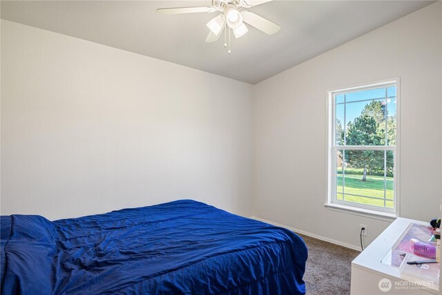 carpeted bedroom featuring ceiling fan, vaulted ceiling, and baseboards