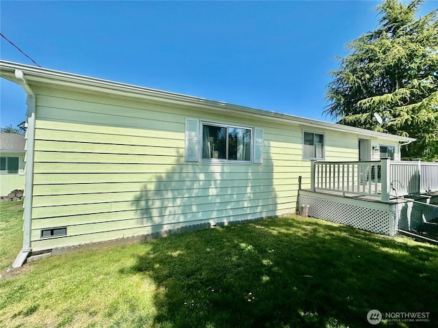 view of property exterior featuring a lawn and a deck
