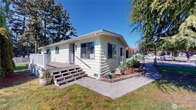 view of front facade with crawl space, a front lawn, fence, and a deck