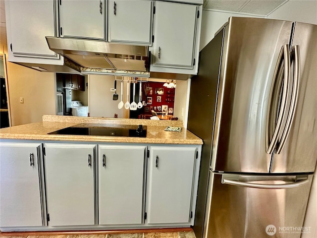 4317 Hamilton Dr, Oak Harbor, WA 98277 - kitchen featuring freestanding refrigerator, under cabinet range hood, and black electric stovetop
