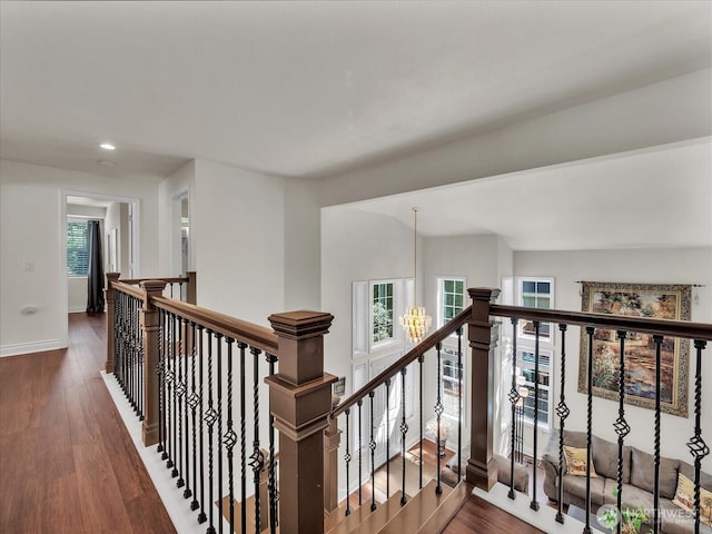 hall featuring baseboards, recessed lighting, wood finished floors, and an upstairs landing