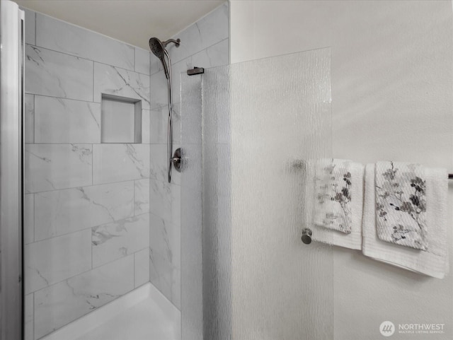 full bath featuring a tile shower